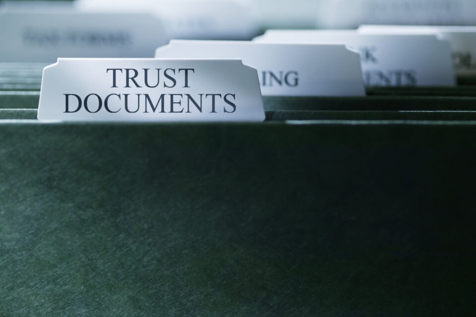 File drawer with labeled dividers reading Trust Documents, Planning, and Documents