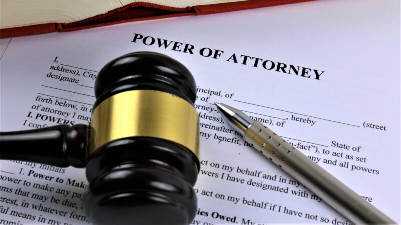Power of Attorney document on a desk next to a gavel